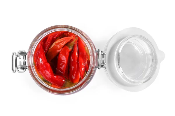 Öppen burk med inlagd röd varm chili paprika på vit bakgrund, ovanifrån — Stockfoto