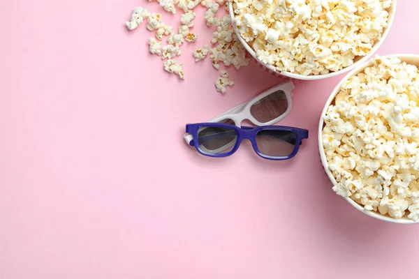 Popcorn und 3D-Brillen auf rosa Hintergrund, flache Lage mit Platz für Text. Kinosnack — Stockfoto