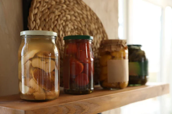 Alimentos enlatados na prateleira de madeira na cozinha moderna — Fotografia de Stock
