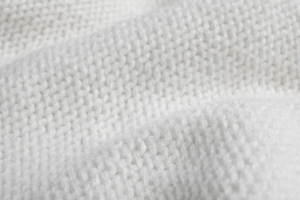 Fehér kötött pulóver, mint a háttér, közelkép — Stock Fotó