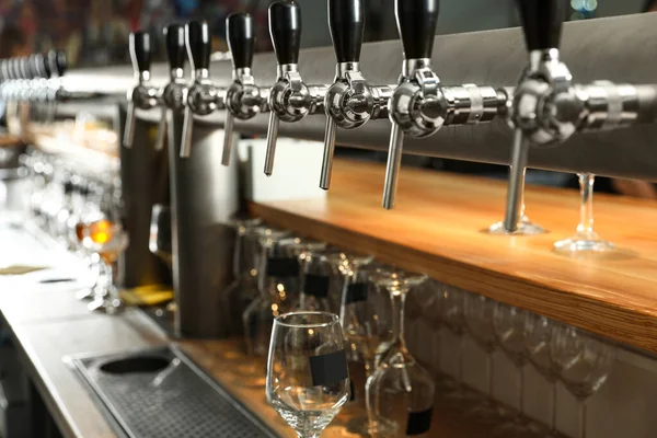 Row of shiny beer taps in pub — Stock Photo, Image