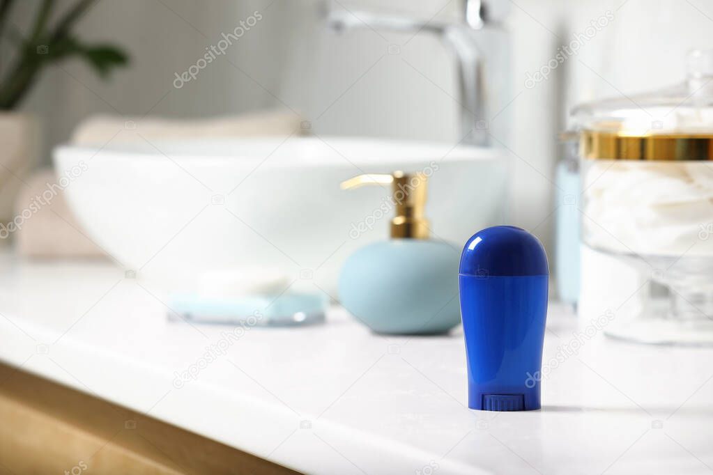 Stick deodorant and different toiletry on countertop in bathroom, space for text