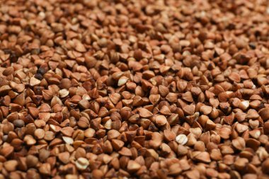 Uncooked organic buckwheat grains as background, closeup clipart