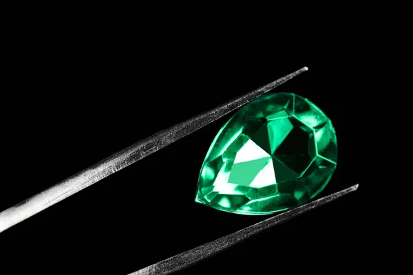 Tweezer with beautiful gemstone on black background — 图库照片