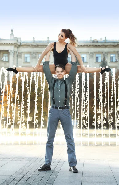 Schönes junges Paar übt Tanz bewegt sich in der Nähe von Brunnen im Freien — Stockfoto