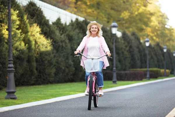 Mujer madura montando bicicleta al aire libre. Estilo de vida activo — Foto de Stock