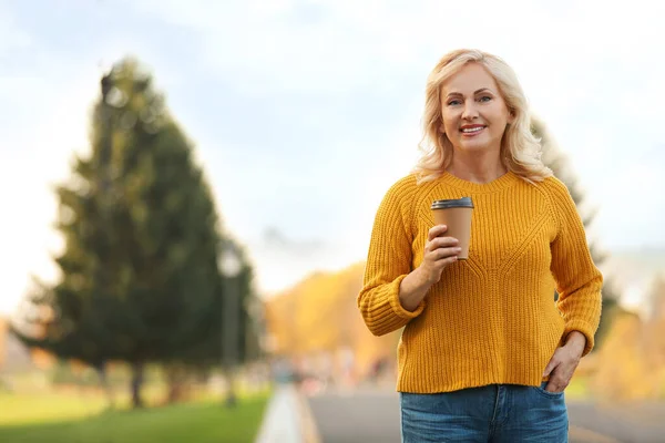 Hermosa mujer madura con taza de café al aire libre — Foto de Stock