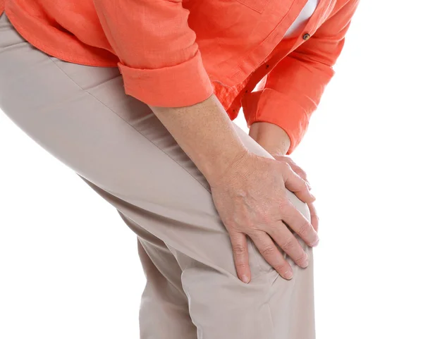 Woman suffering from knee pain on white background, closeup — Stock Photo, Image