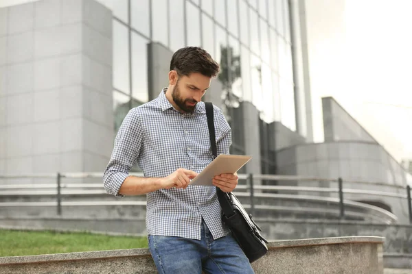 Bonito homem trabalhando com tablet na rua da cidade — Fotografia de Stock