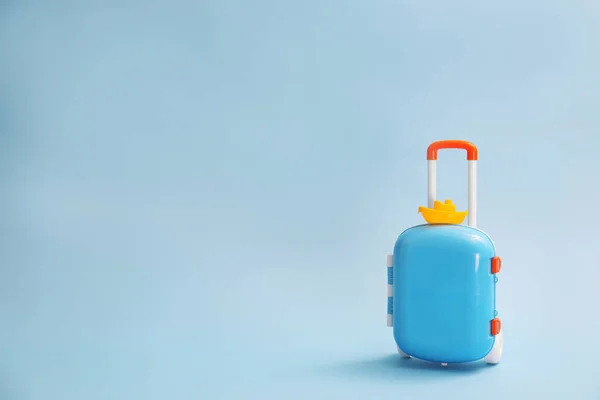 Stylish child suitcase with toy on blue background, space for text — Zdjęcie stockowe