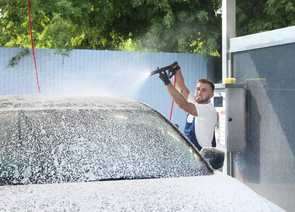 세차장에서 고압 물탱크를 사용하여 자동차를 청소하는 젊은 근로자들 — 스톡 사진