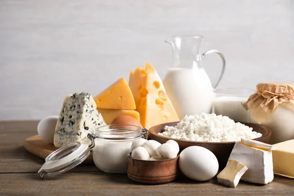 Ahşap masada farklı lezzetli süt ürünleri — Stok fotoğraf