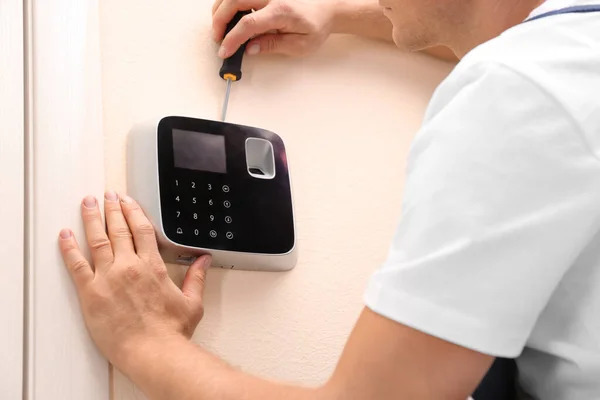 Male technician installing security alarm system indoors, closeup — Stock Photo, Image