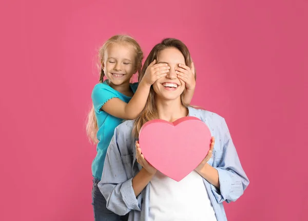 Hijita felicitando a su madre por el fondo rosa. Feliz Día de la Madre — Foto de Stock