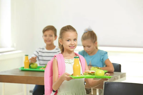 Happy children eating healthy food for lunch in school canteen — Stock Photo, Image