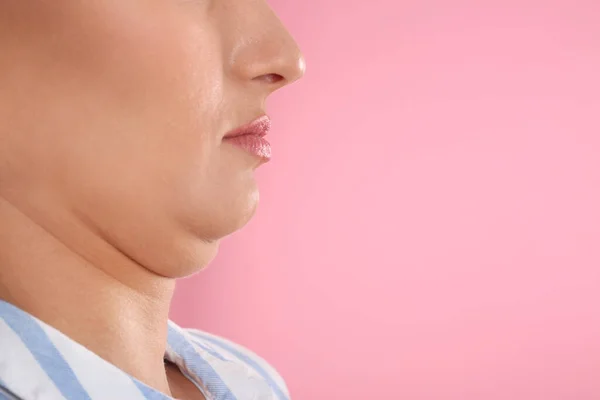 Young woman with double chin on pink background, closeup. Space for text — Stock Photo, Image