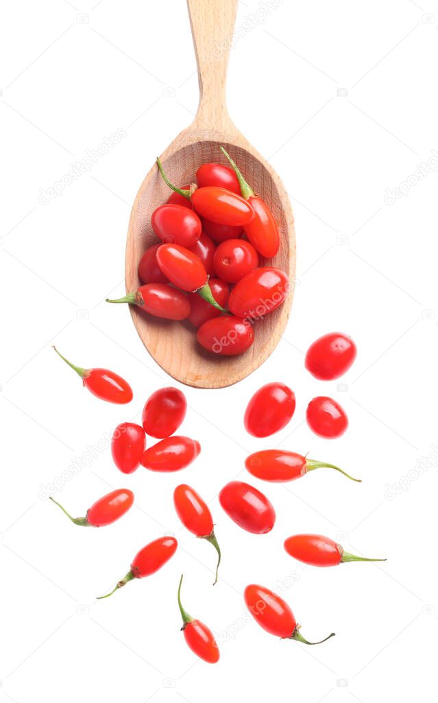 Fresh ripe goji berries and spoon on white background, top view
