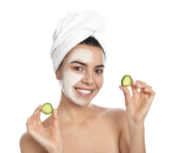 Happy young woman with organic mask on her face holding cucumber slices against white background — Stock Photo, Image