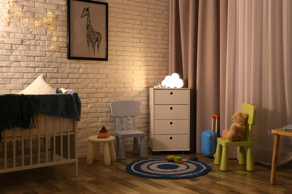 Modern baby room interior with white chest of drawers in evening — ストック写真
