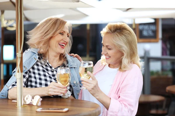 Mature women with drinks at outdoor cafe — Stock Photo, Image