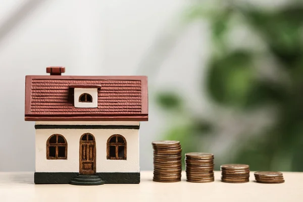 House model and coins on table. Money savings — Stock Photo, Image