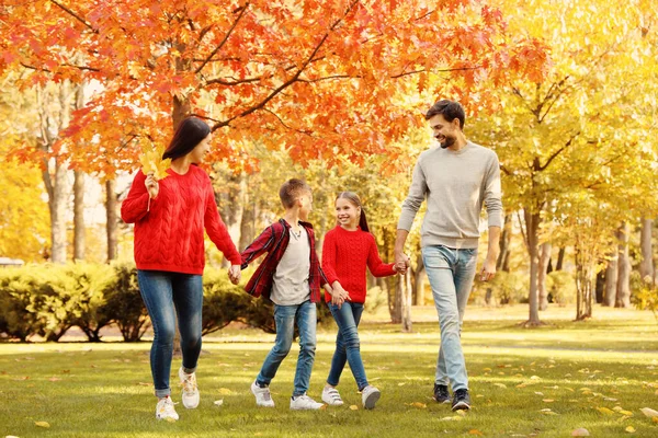 Família feliz com crianças andando no parque de outono — Fotografia de Stock