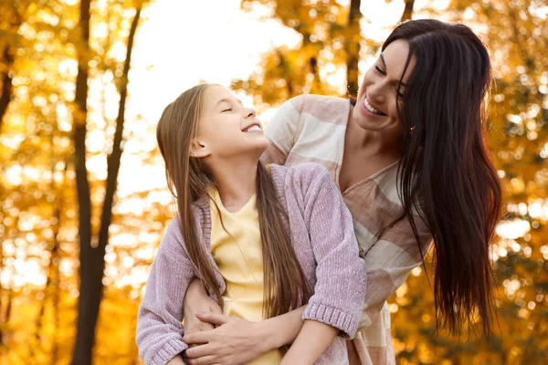 Happy mother with daughter in sunny park. Autumn walk — Stock Photo, Image