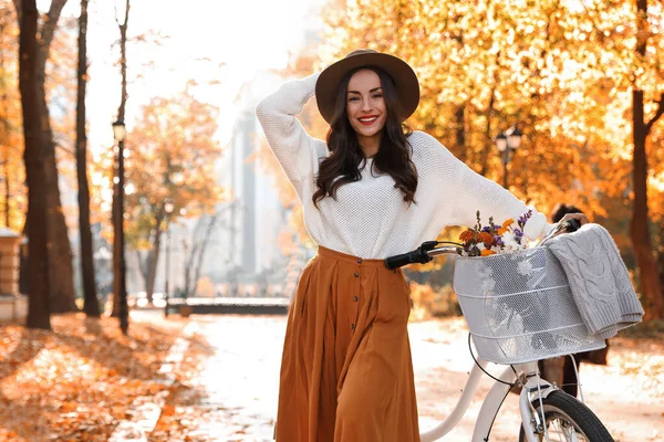 Beautiful happy woman with bicycle in autumn park — Stok fotoğraf