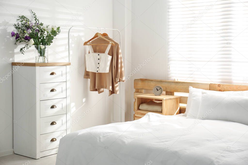Stylish bedroom with modern chest of drawers