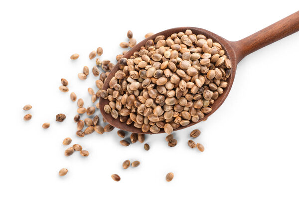 Wooden spoon with hemp seeds on white background, top view