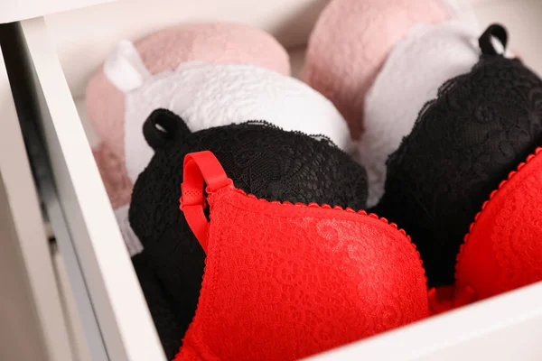 Drawer with beautiful lace bras, closeup. Stylish underwear — Stock Photo, Image