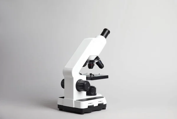 Modern microscope on grey background. Medical equipment — Φωτογραφία Αρχείου