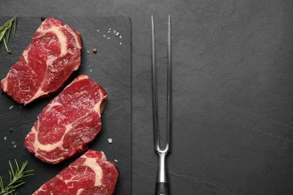 Flat lay composition with fresh meat steaks on dark table. Space for text — Stock Photo, Image