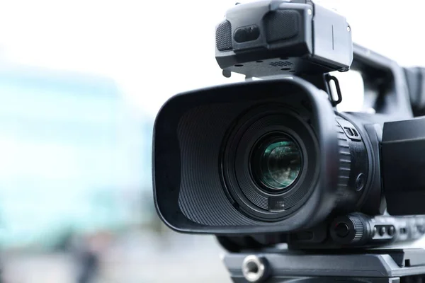 Professional video camera on city street, closeup