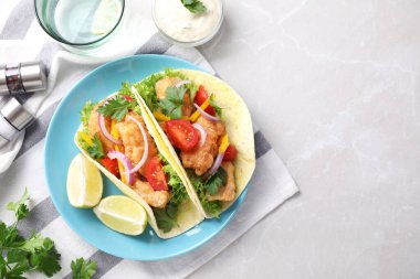 Yummy fish tacos served on marble table, flat lay. Space for text clipart