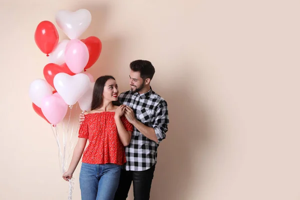 Beautiful Couple Heart Shaped Balloons Beige Background Space Text Valentine — Stock Photo, Image