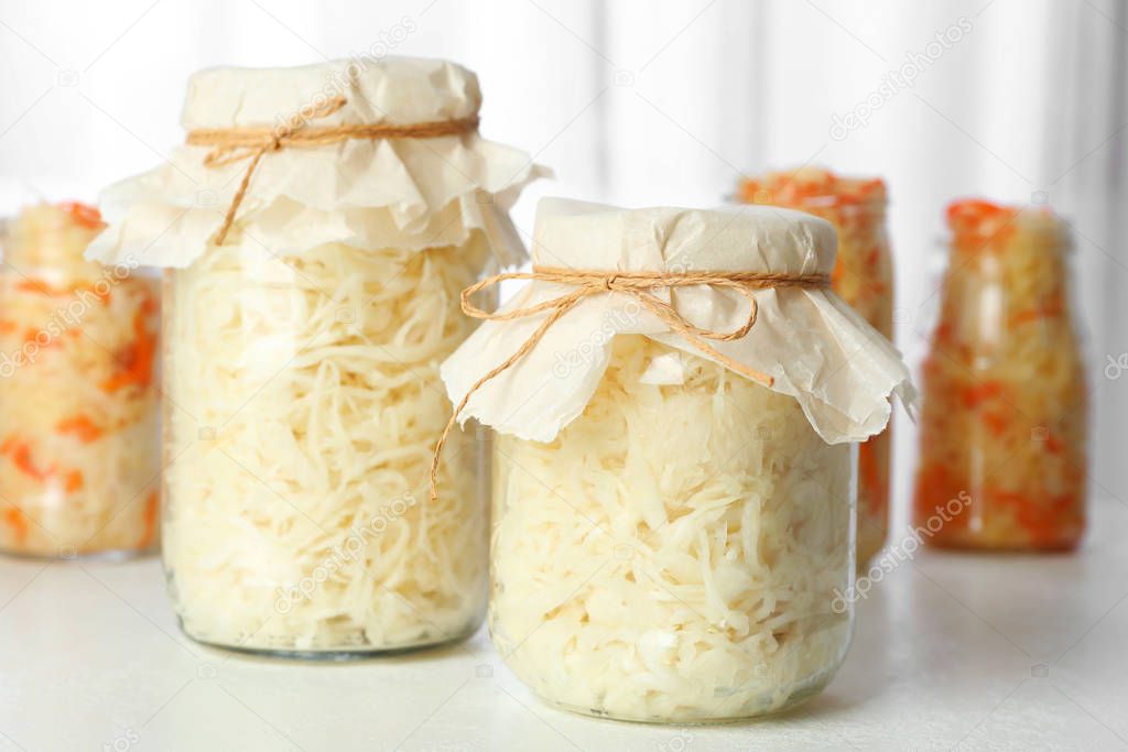 Tasty homemade fermented cabbage on white table