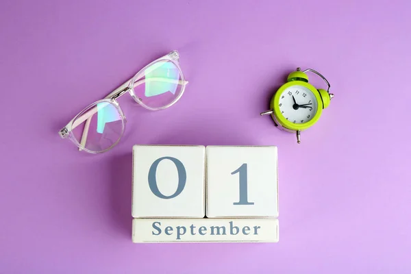 紫罗兰色背景的日历 眼镜和闹钟 — 图库照片