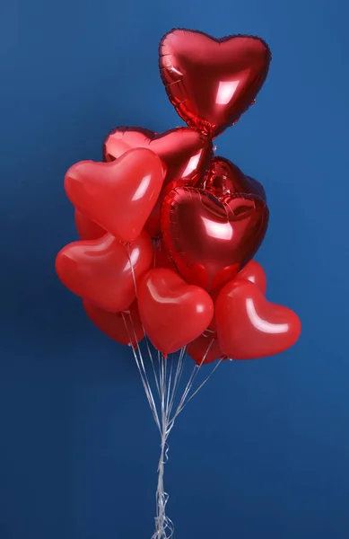 Bunch of heart shaped balloons on blue background. Valentine's day celebration