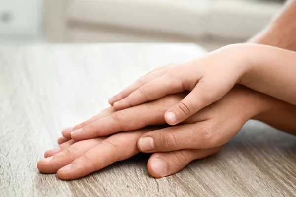 Happy Family Holding Hands Wooden Table Indoors Closeup View — Stock Photo, Image