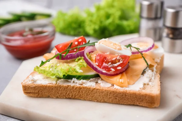 Delicious sandwich served on light table, closeup