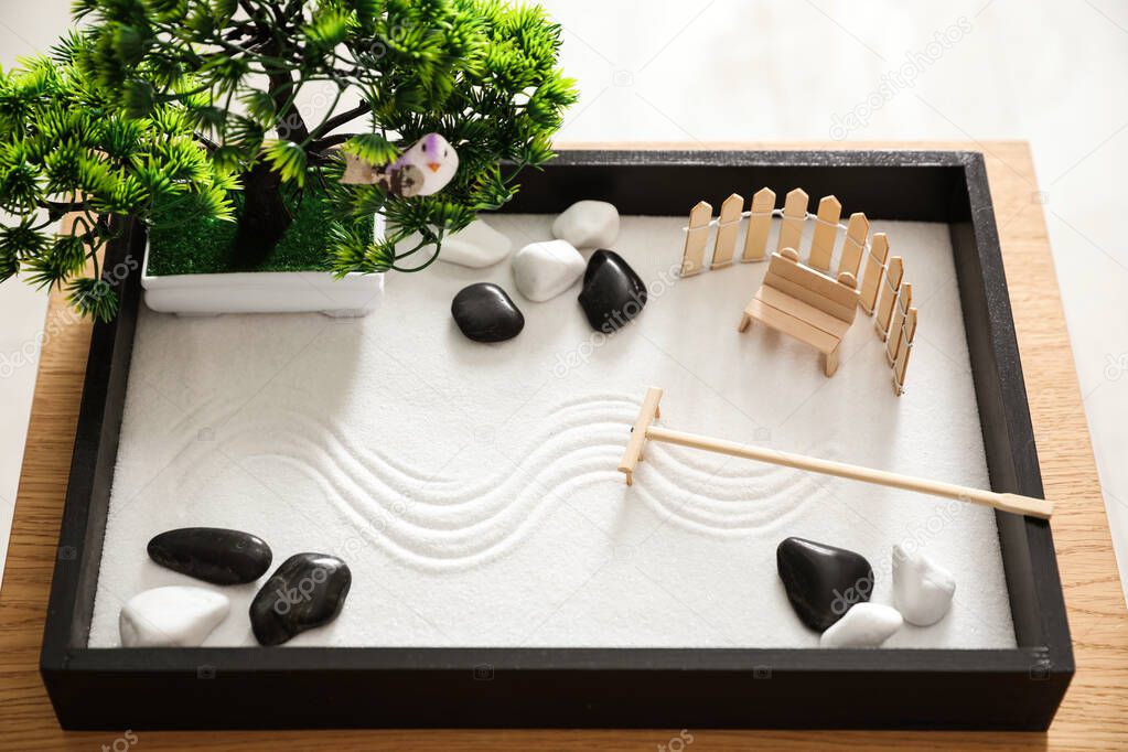 Beautiful miniature zen garden on wooden table