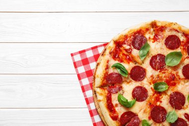 Beyaz ahşap masa üzerinde sıcak, lezzetli pepperoni pizza, üst manzara. Metin için boşluk