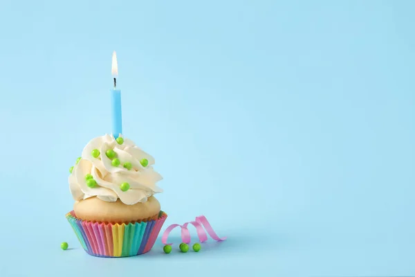 Magdalena de cumpleaños con vela sobre fondo azul claro. Espacio para —  Fotos de Stock