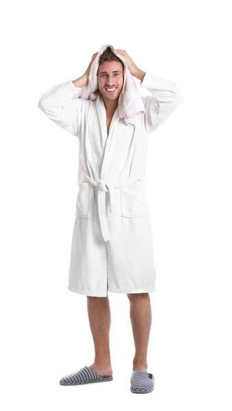 Hombre joven en albornoz secado pelo con toalla sobre fondo blanco —  Fotos de Stock