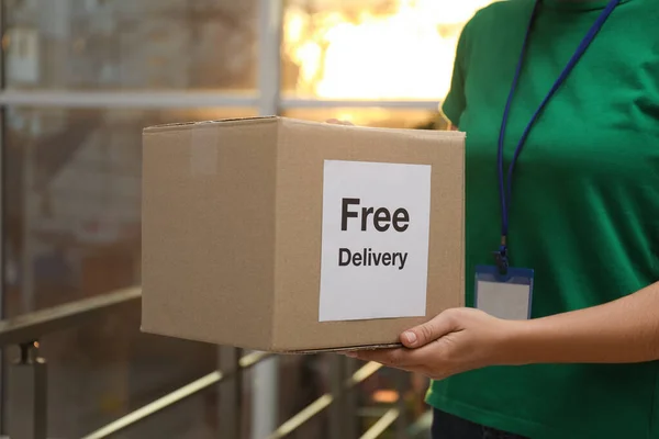 Courier Holding Parcel Sticker Free Delivery Indoors Closeup — Stock Photo, Image