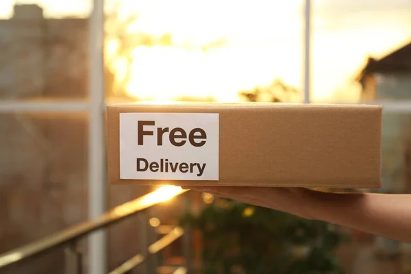 Courier Holding Parcel Sticker Free Delivery Indoors Closeup — Stock Photo, Image