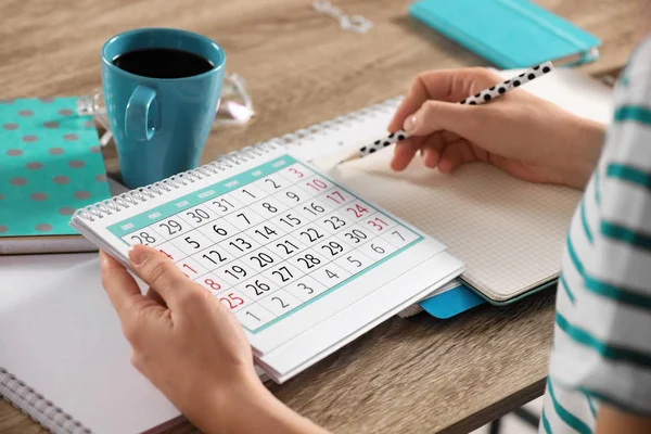 Woman Making Schedule Using Calendar Wooden Table Closeup — Stock Photo, Image