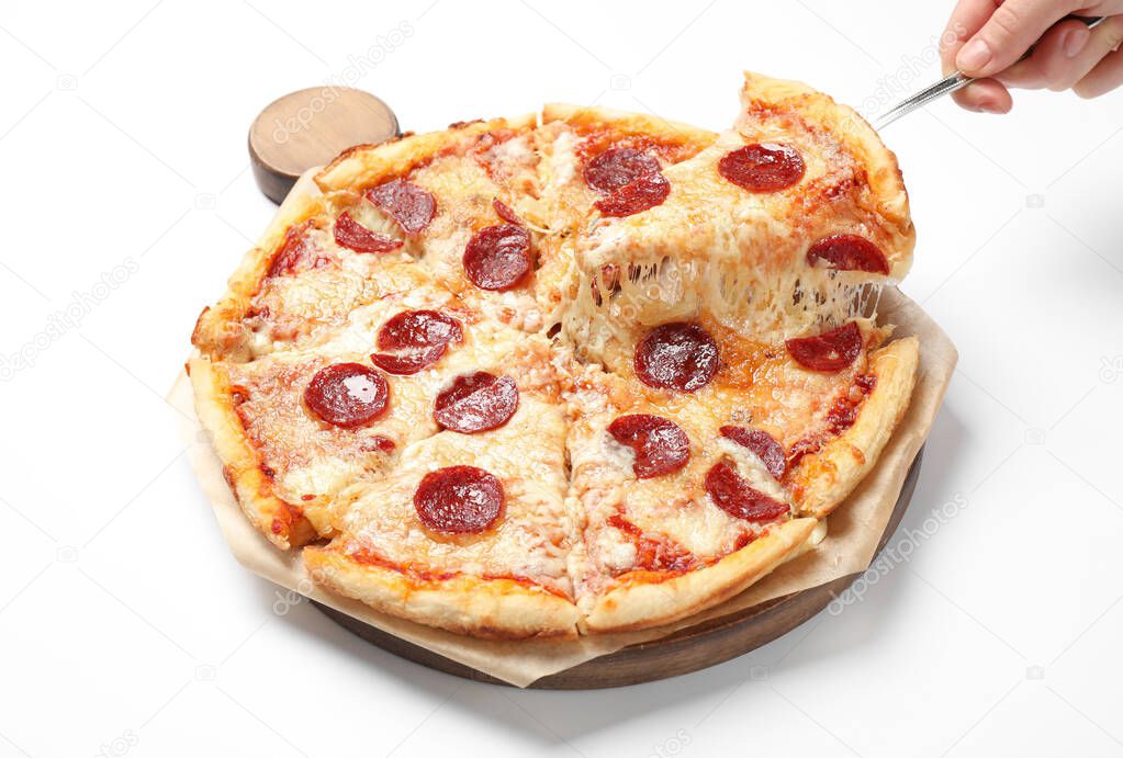 Woman taking slice of tasty pepperoni pizza on white background, closeup