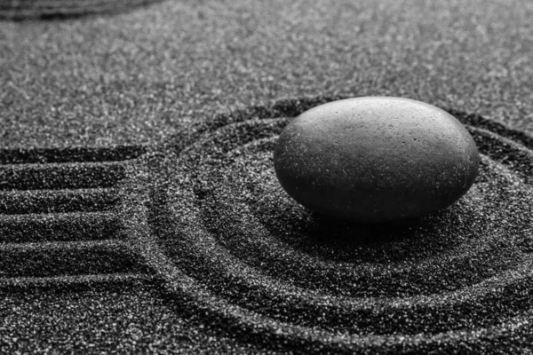 Black sand with stone and beautiful pattern. Zen concept